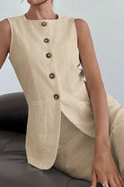 Beige sleeveless cotton-linen blend vest with buttons paired with matching high-waisted skirt