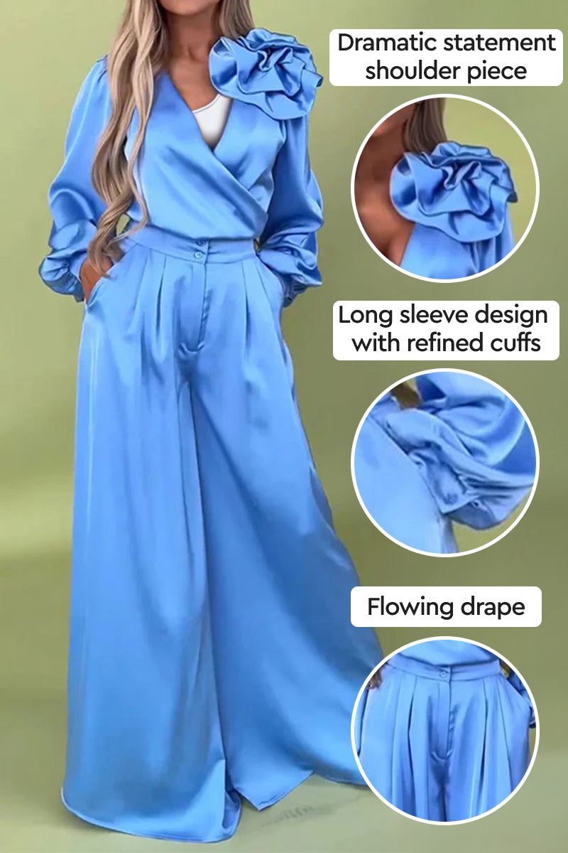 Elegant blue satin two-piece set with statement shoulder and flowing palazzo pants