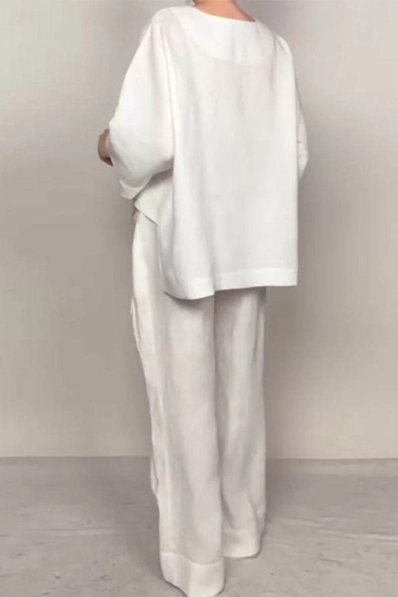 woman wearing white Atelier Serenity layered two-piece set with loose top and wide-leg pants back view