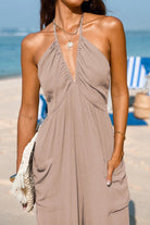 Women's Sunshine On Sand halter-neck jumpsuit with ruched neckline and wide-leg silhouette on beach background