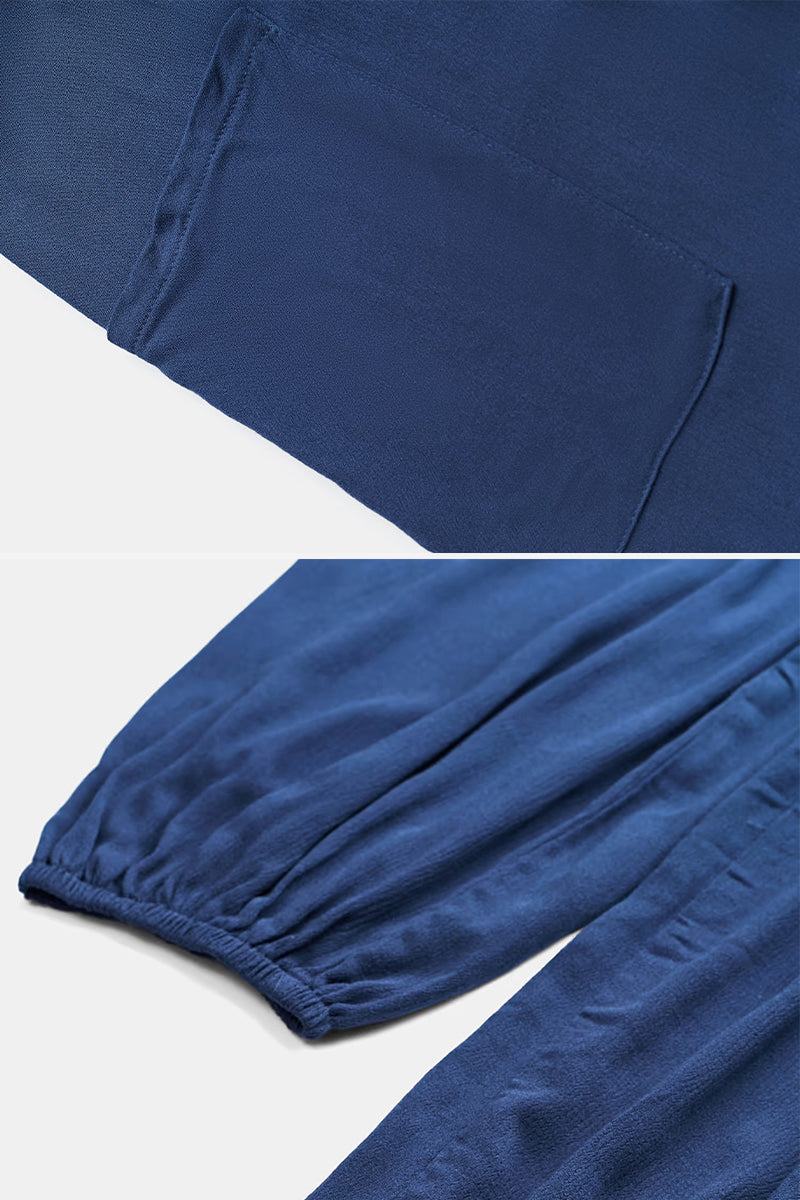 Close-up details of blue Sunshine On Sand halter-neck jumpsuit fabric with pocket and elastic ankle cuff features