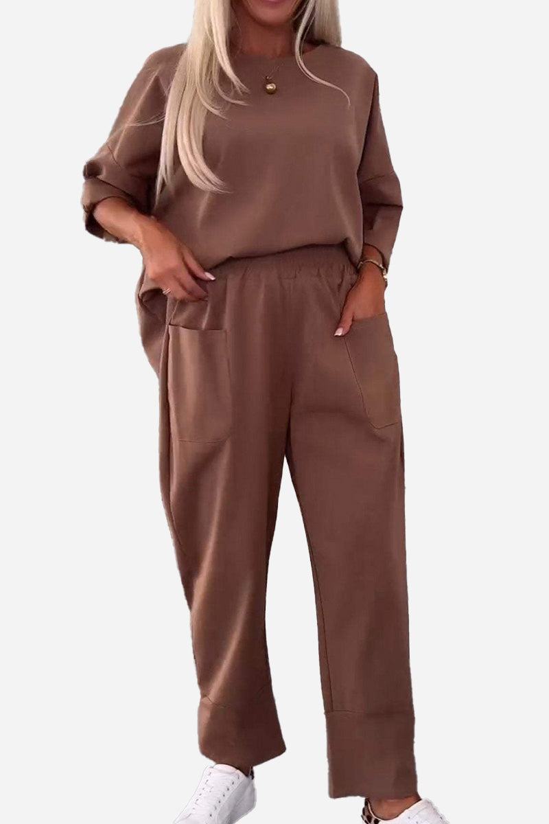 Woman wearing brown relaxed fit two-piece set with crew neck sweatshirt and jogger pants with side pockets