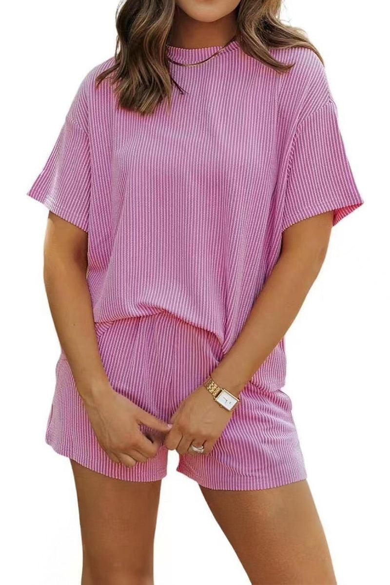 Women wearing relaxed fit pink textured two-piece set for slow mornings with short sleeves and shorts