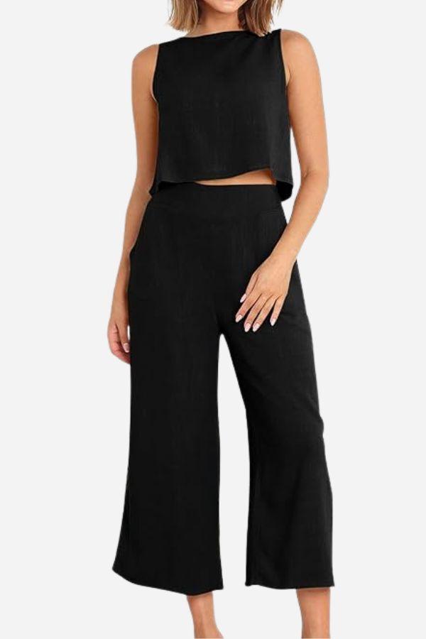 Woman wearing black Villa Lounge Linen Set with sleeveless crop top and wide-leg pants