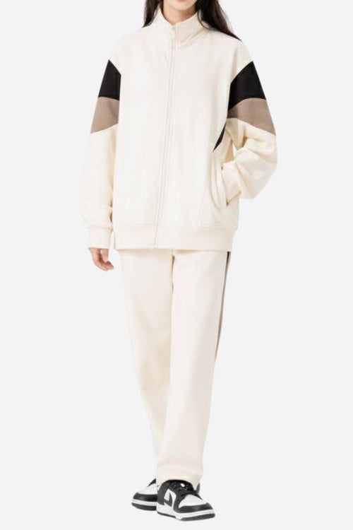Woman wearing Comfort in Motion lightweight athleisure tracksuit set in white with black and brown sleeve accents