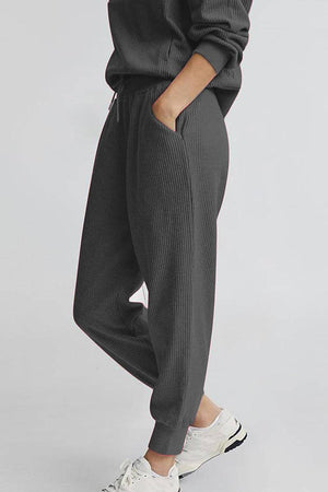 Unisex half-zip pullover and sweatpants set in dark gray, soft polyester blend, casual and comfortable fit