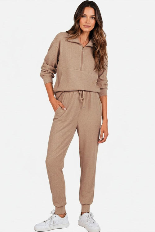 Unisex half-zip pullover and sweatpants set in beige with stand collar, casual fit, and lightweight polyester blend.