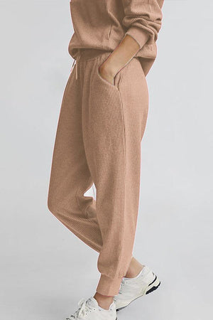 Unisex half-zip pullover and sweatpants set in beige ribbed fabric with casual fit and white sneakers