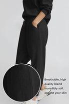 Unisex half-zip pullover and sweatpants set in breathable soft black polyester blend