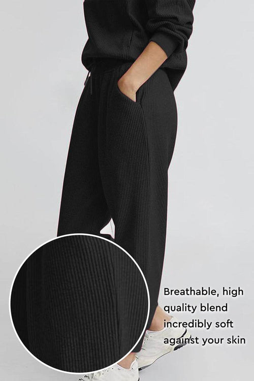 Unisex half-zip pullover and sweatpants set in breathable soft black polyester blend