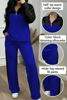 Woman wearing blue and black colorblock comfort leisure set with half-zip stand collar and wide-leg pants