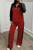 Woman wearing red and black Colorblock Comfort Leisure Set with half-zip top and wide-leg pants.