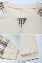 Cream waffle knit sweatshirt with plaid sleeves and v-notch neckline detail close-up shots
