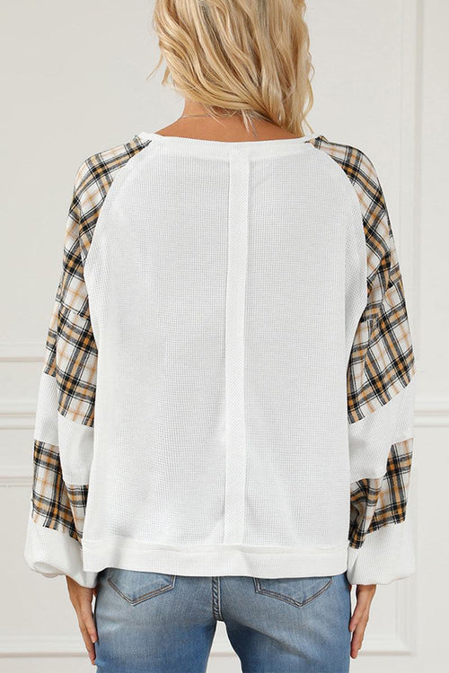 Waffle knit sweatshirt with white textured body and plaid flannel sleeves, relaxed fit back view