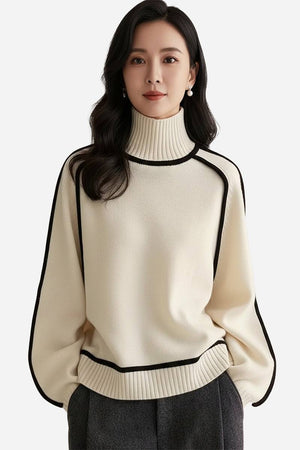 Woman wearing a cream Zero Itch Turtleneck Sweater with black contrast trim and relaxed fit