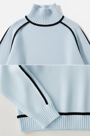 Light blue Zero Itch Turtleneck Sweater with black contrast trim, soft knit, and slimming fit.