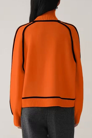Orange Zero Itch Turtleneck Sweater with black contrast trim, soft knit, and relaxed fit shown from the back
