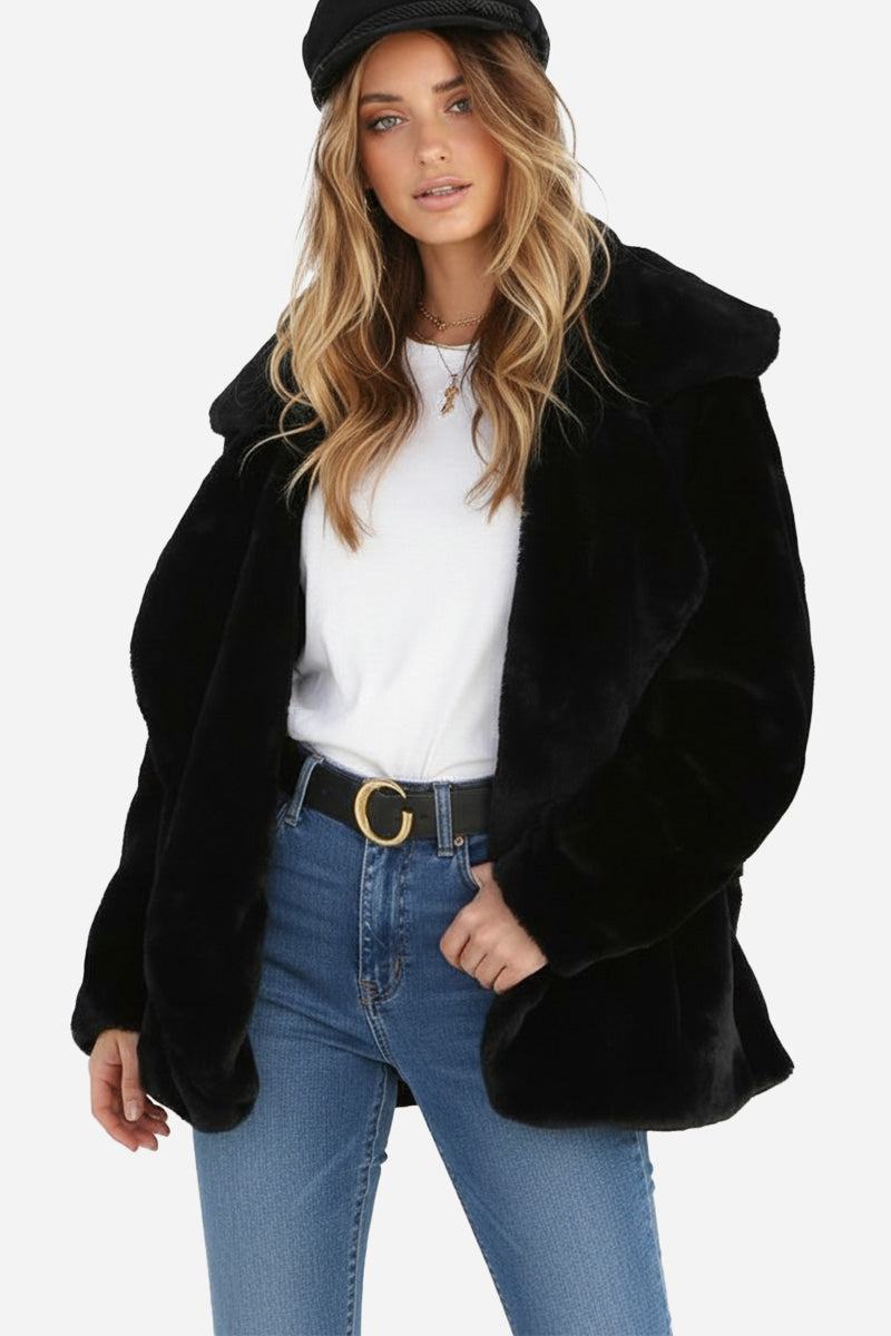 Woman wearing open front oversized black faux fur jacket with draped collar and relaxed fit