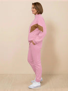 Woman wearing a colorblock comfort tracksuit with contrast curved panels and a stand collar jacket