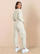 Woman wearing 100% cotton waffle knit set with long sleeves and cargo pockets, styled with white sneakers