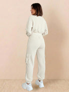 Woman wearing beige cotton waffle knit set with long sleeves and cargo pants viewed from back