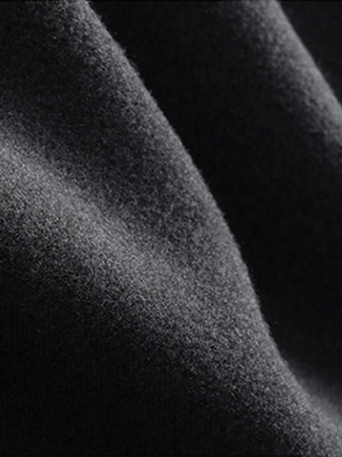 Close-up of soft black lyocell-blend fabric texture from hooded set