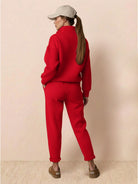 Woman wearing red warm & easy two-piece set with hoodie and matching pants, casual comfortable outfit from behind