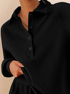 woman wearing wrinkle-free polo set with quarter-button top and high-waisted pants standing against white background