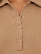 Woman wearing a wrinkle-free polo set with quarter-button top and high-waisted pants