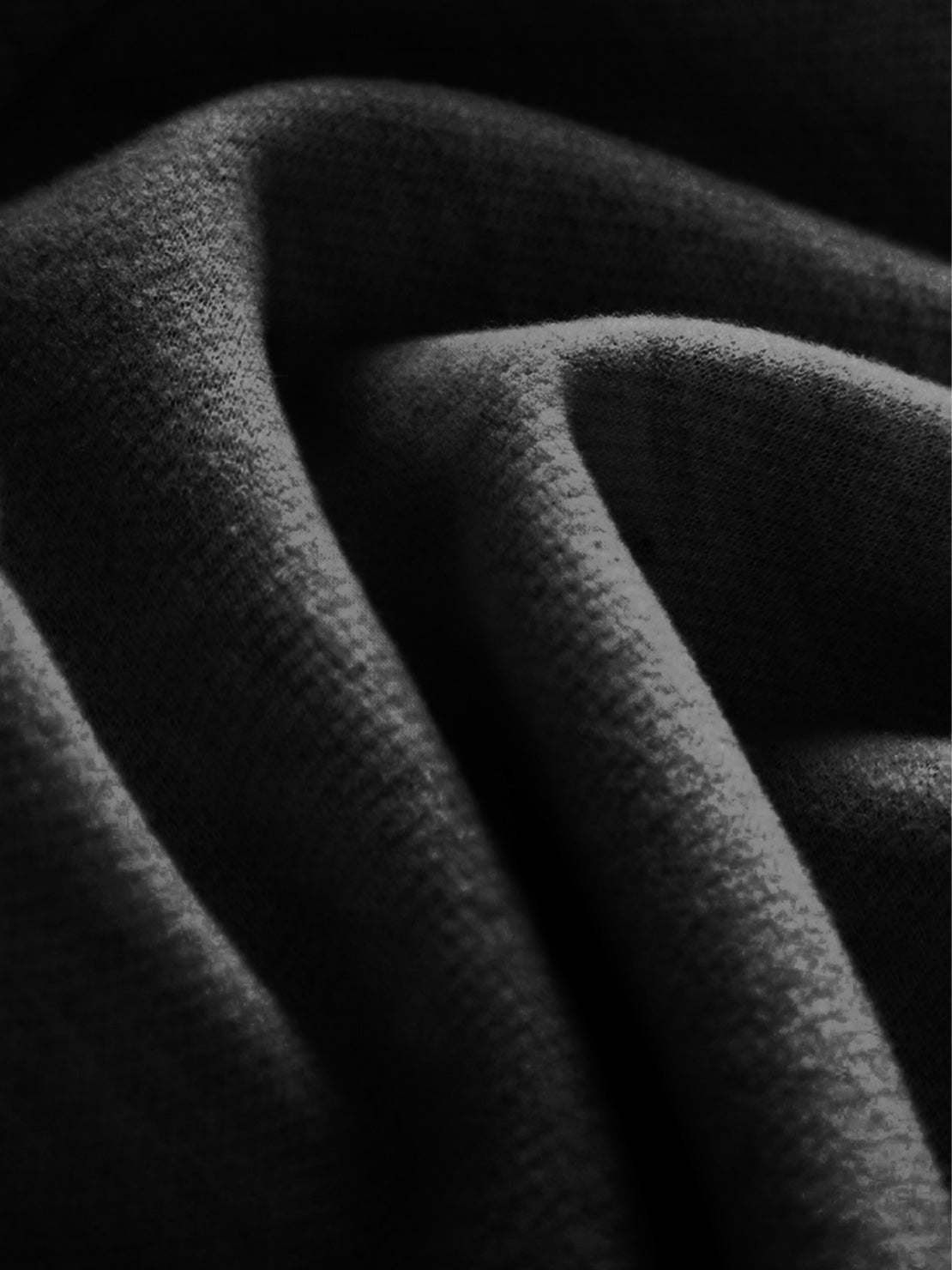 Close-up of soft black thermal wool blend fabric for warm, wide-leg trousers