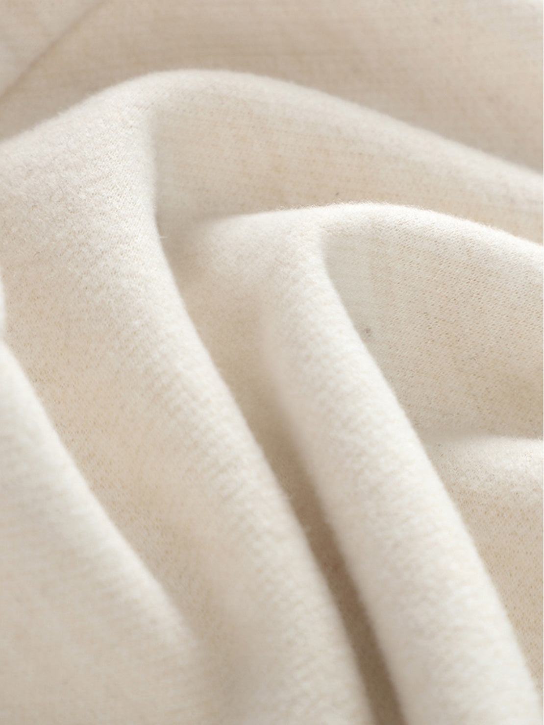 Close-up of soft beige thermal wool blend fabric for warm winter trousers