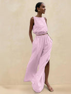 Lightweight linen-blend set with sleeveless top and wide-leg pants featuring elastic waistband and side slits for breathability