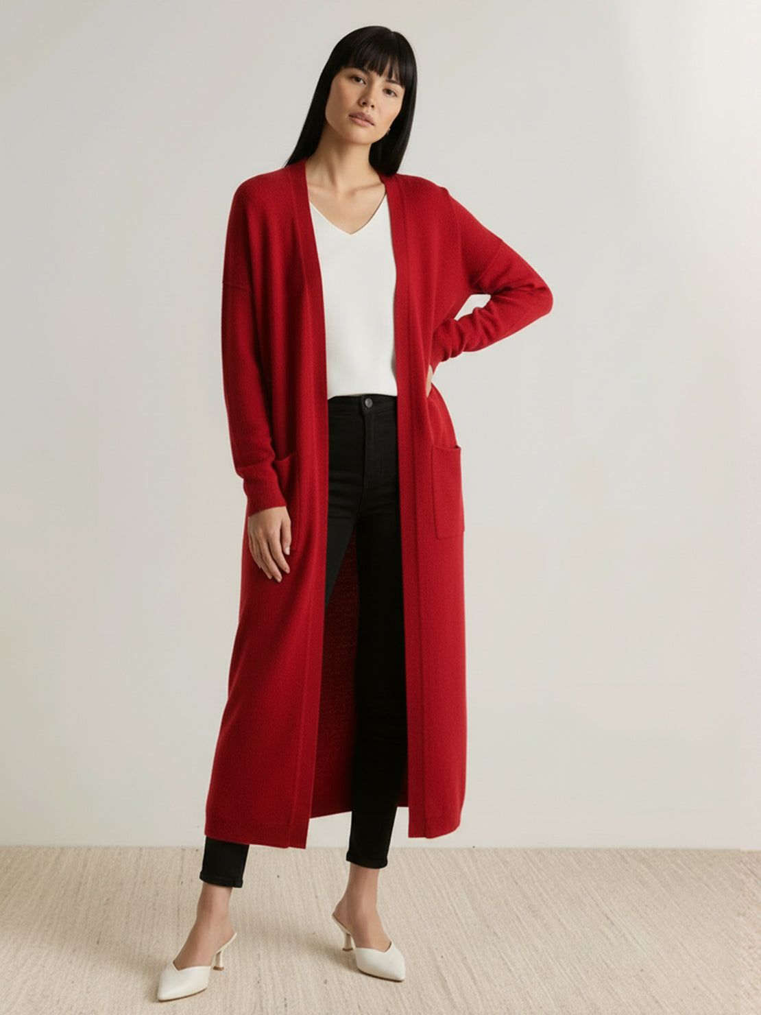 Long Australian Merino Wool cardigan with open front, patch pockets, and ribbed cuffs for versatile layering and natural temperature regulation