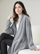 Long Australian Merino Wool cardigan with open front, ribbed cuffs, and patch pockets for layered warmth and style.