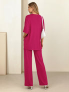 Woman wearing oversized long-line loungewear set with pullover and wide-leg pants.