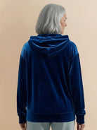Ultra-soft velvet half-zip hoodie with hood and kangaroo pocket, plush texture and relaxed fit