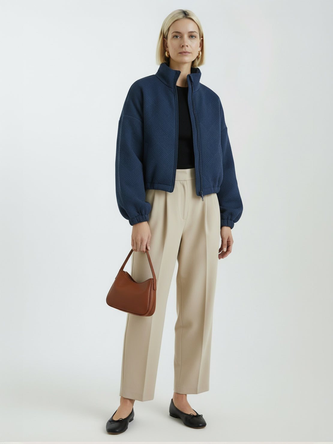 Cropped textured baseball jacket with full-zip, elastic cuffs, and waistband, styled for casual wear