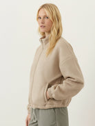 Cropped textured baseball jacket with full zipper, stand collar, elastic cuffs, and waistband designed for casual layering.