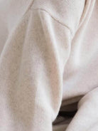 Oversized crew neck knit sweater with drop-shoulder sleeves and ribbed cuffs in neutral color