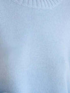 Oversized crew neck knit sweater with drop-shoulder sleeves and ribbed cuffs in neutral color