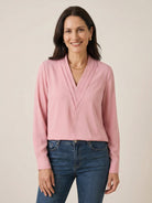 White pleated V-neck long-sleeve blouse with diagonal panel and button cuffs