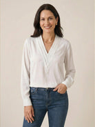 White pleated V-neck long-sleeve blouse with button cuffs and relaxed fit