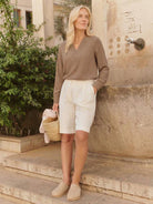 Pleated V-neck long-sleeve blouse with diagonal panel and button cuffs