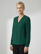 White pleated V-neck long-sleeve blouse with button cuffs and relaxed fit