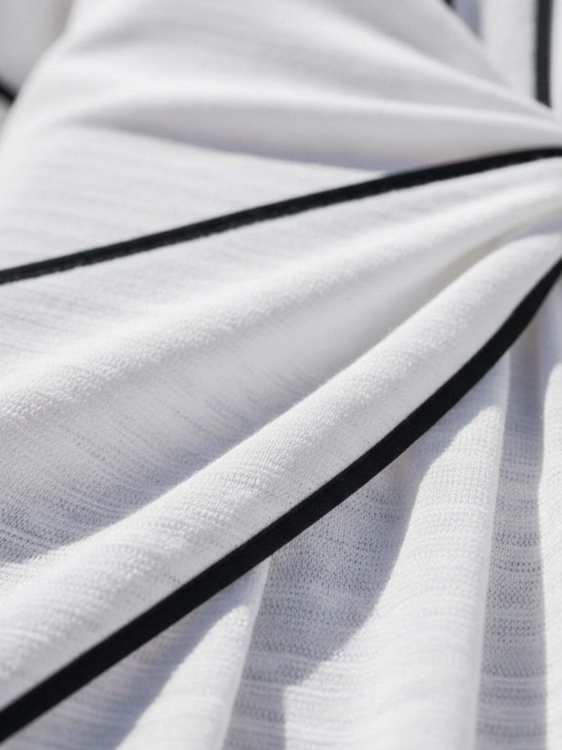 Woman wearing a knot-waist maxi dress with V-neckline, batwing sleeves, and flowing skirt with pockets