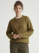 Oversized cable-knit crewneck sweater with dropped shoulders and ribbed trim