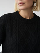 Oversized cable-knit crewneck sweater with dropped shoulders and ribbed trim in thick plush fabric