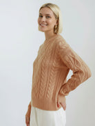 Oversized cable-knit crewneck sweater with dropped shoulders and ribbed trim