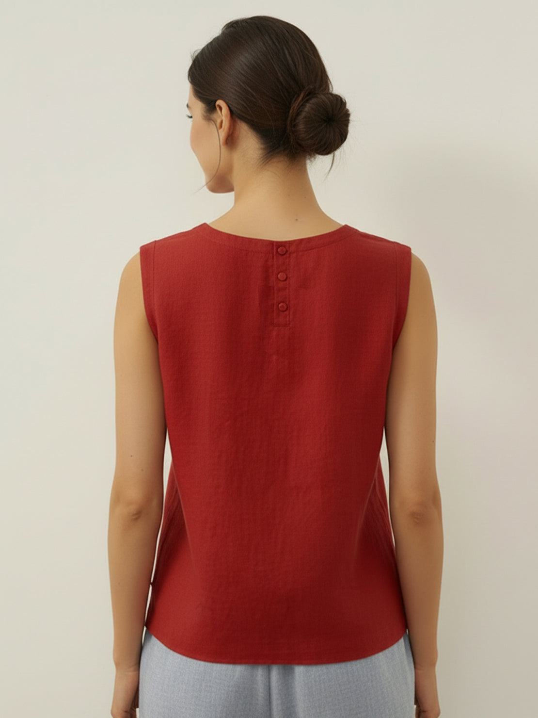 White cotton-linen sleeveless top with round neckline and relaxed A-line fit