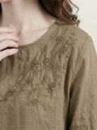 100% cotton-linen embroidered blouse with relaxed fit, balloon sleeves, and subtle floral detail on shoulder